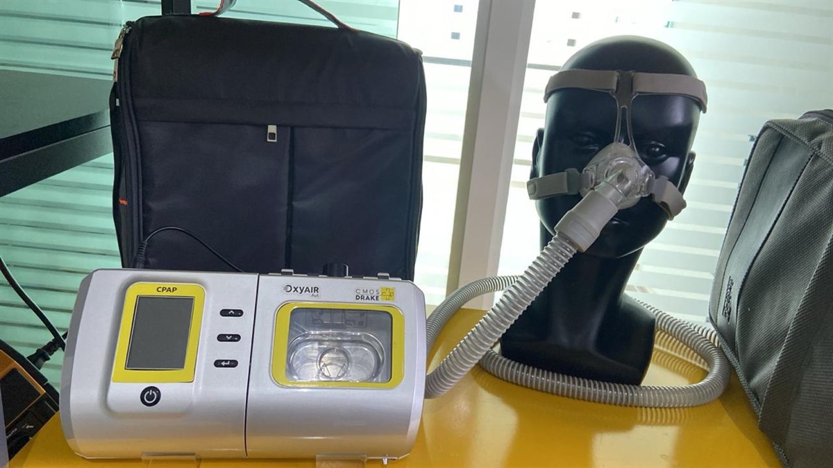 CPAP OxyAir Aut CMOS Drake ao lado da bolsa de transporte e da traqueia, com máscara opcional montada em manequim